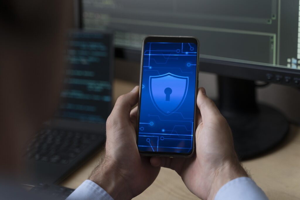 Related image in Career Development category for ISO/IEC 27034: Embedding Security into the Application Lifecycle post | close up hands holding smartphone