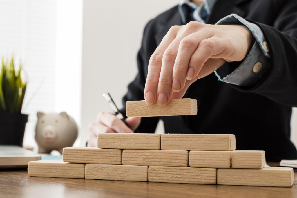 Related image in Career Development category for Building the Workforce for ISO/IEC Standards: Four Essential Roles post | front view businessman with wooden building blocks